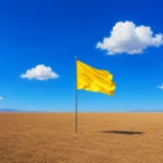 Bandera amarilla plantada en un paisaje vacío, metáfora del territorio de marca que una marca decide ocupar